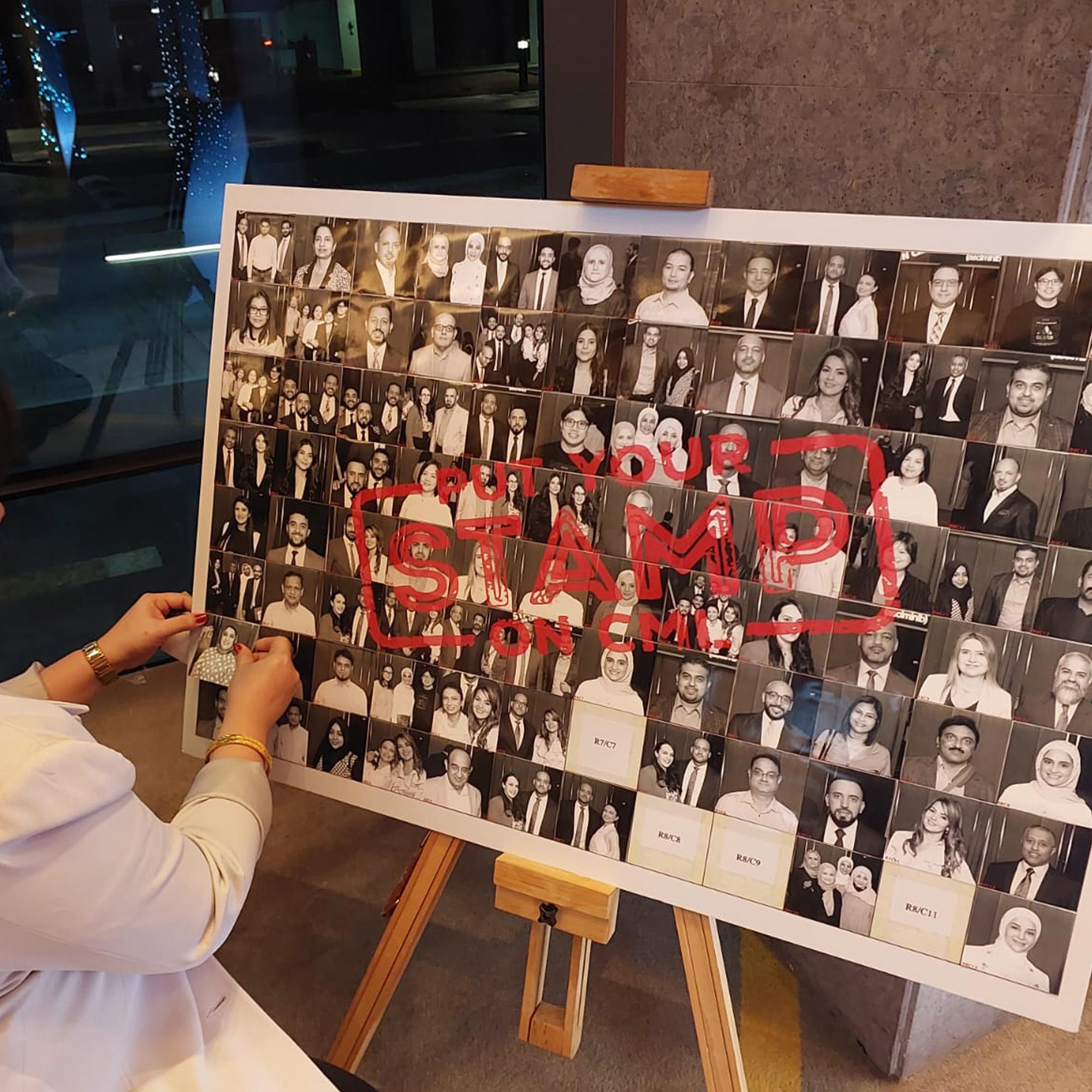 Guests adding photos to a digital mosaic wall, creating a collaborative image masterpiece at a live event.