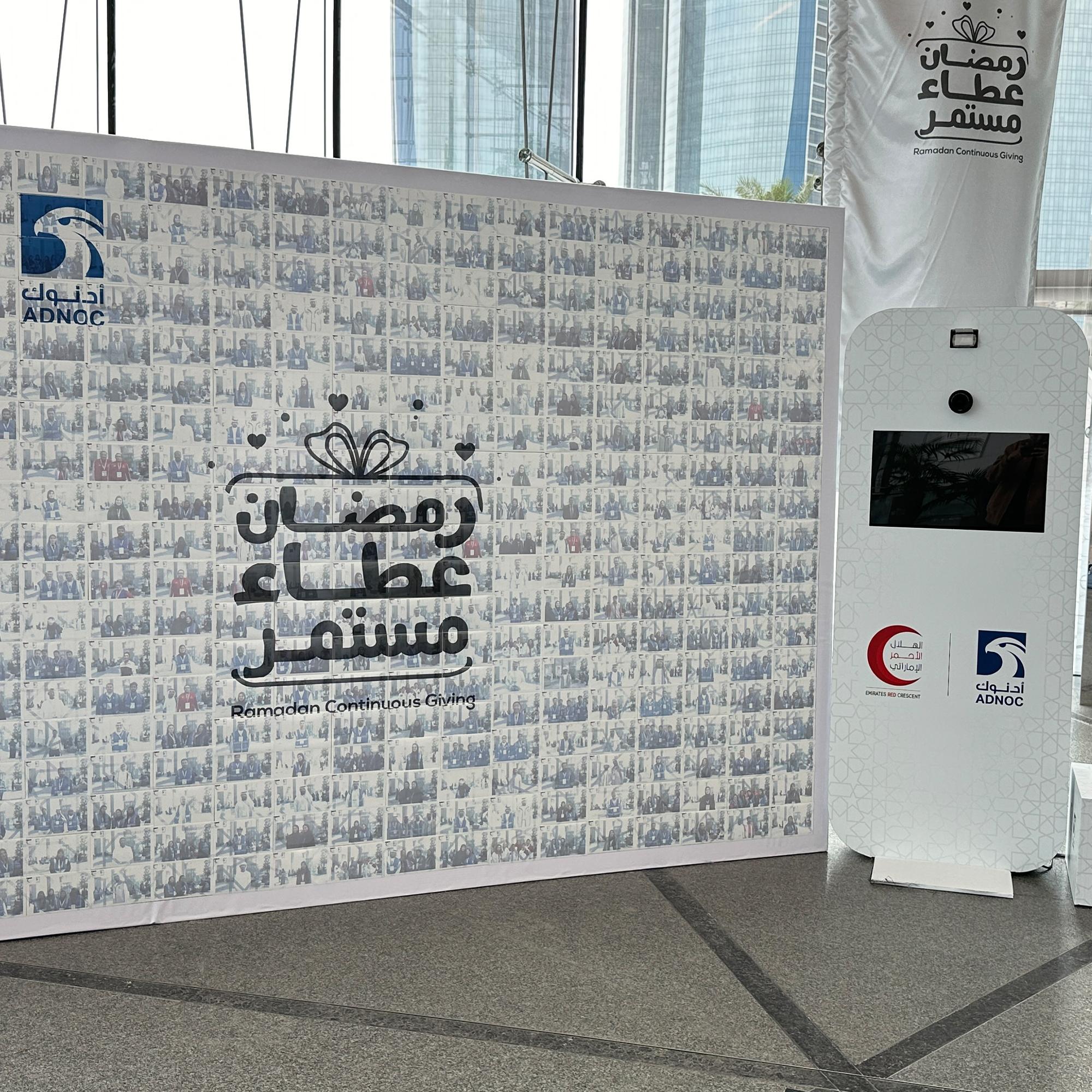 Guests adding photos to a digital mosaic wall, creating a collaborative image masterpiece at a live event.