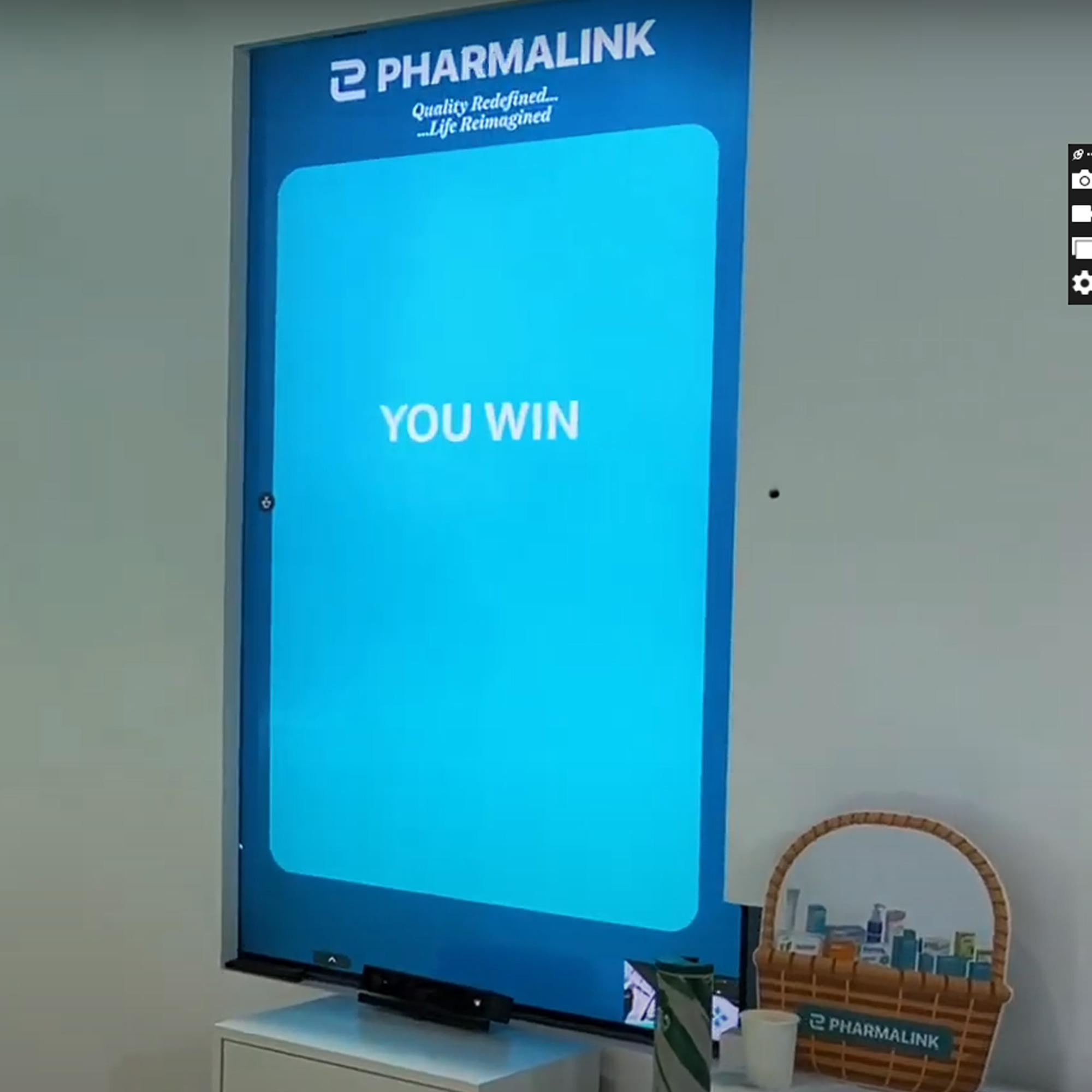 Player using body to slash branded items in a motion sensor game at exhibition in Dubai