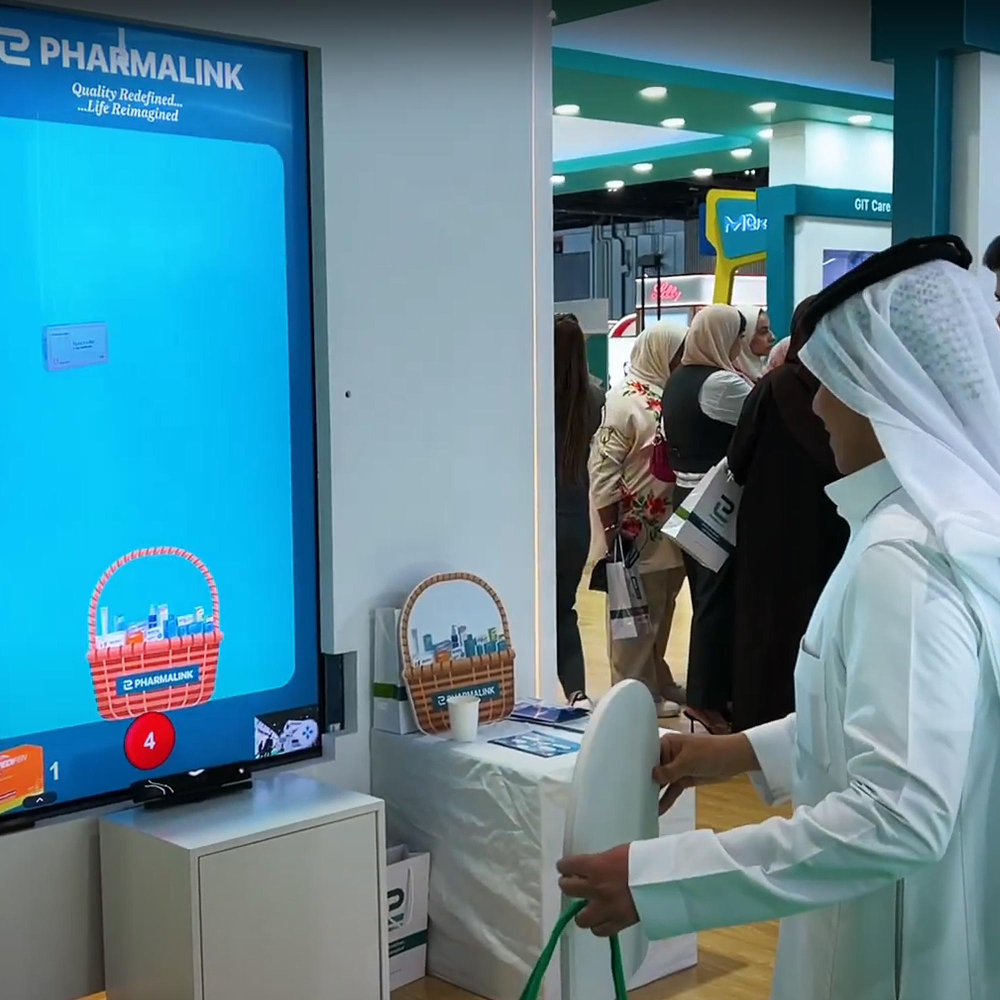 Player using body to slash branded items in a motion sensor game at exhibition in Dubai