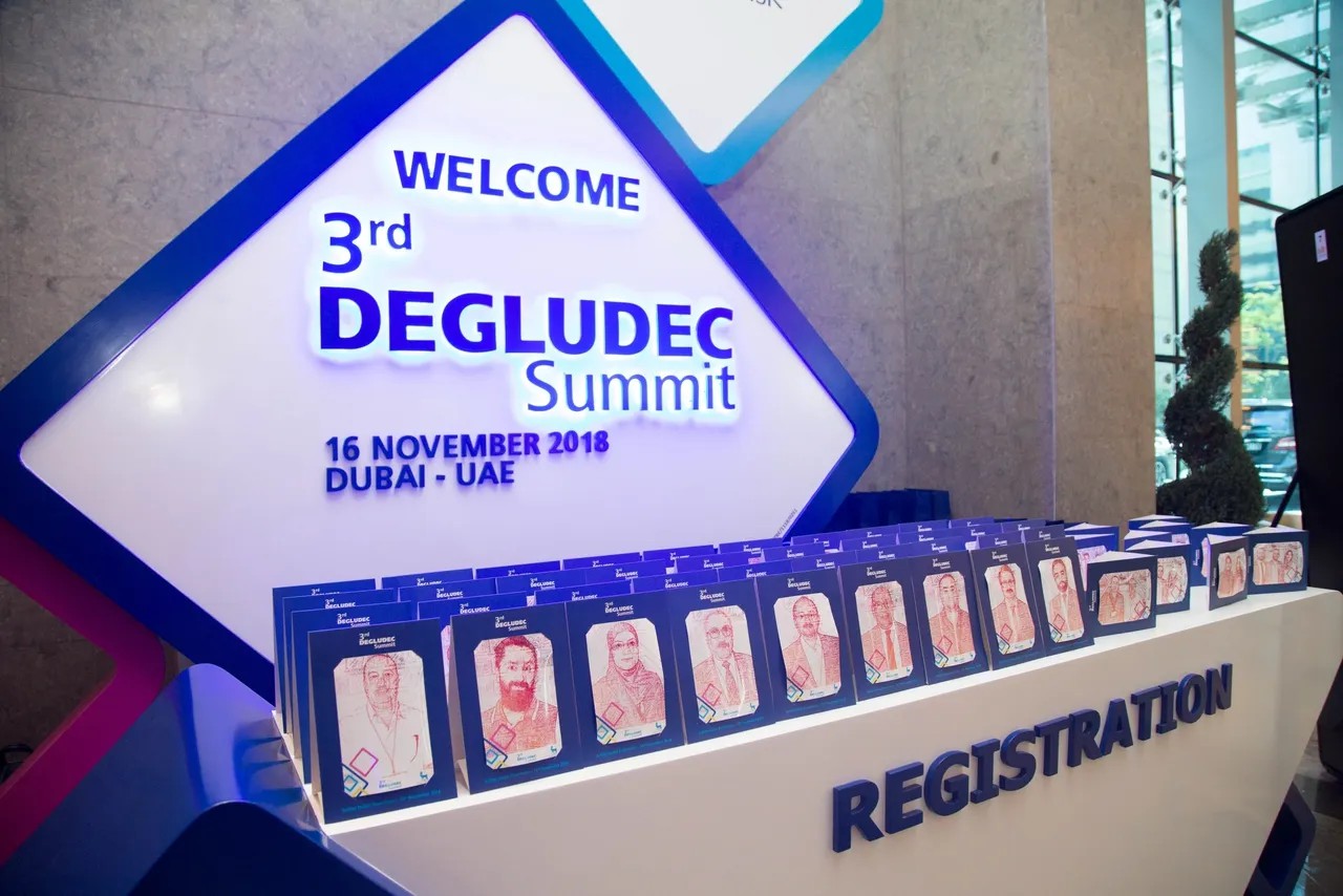 Guest using Text Selfie Photo Booth at an event in Dubai, receiving a printed word cloud image made from their photo with custom branded text for marketing activation