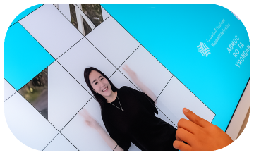 Player solving a shuffled photo puzzle of their face during an interactive event challenge.